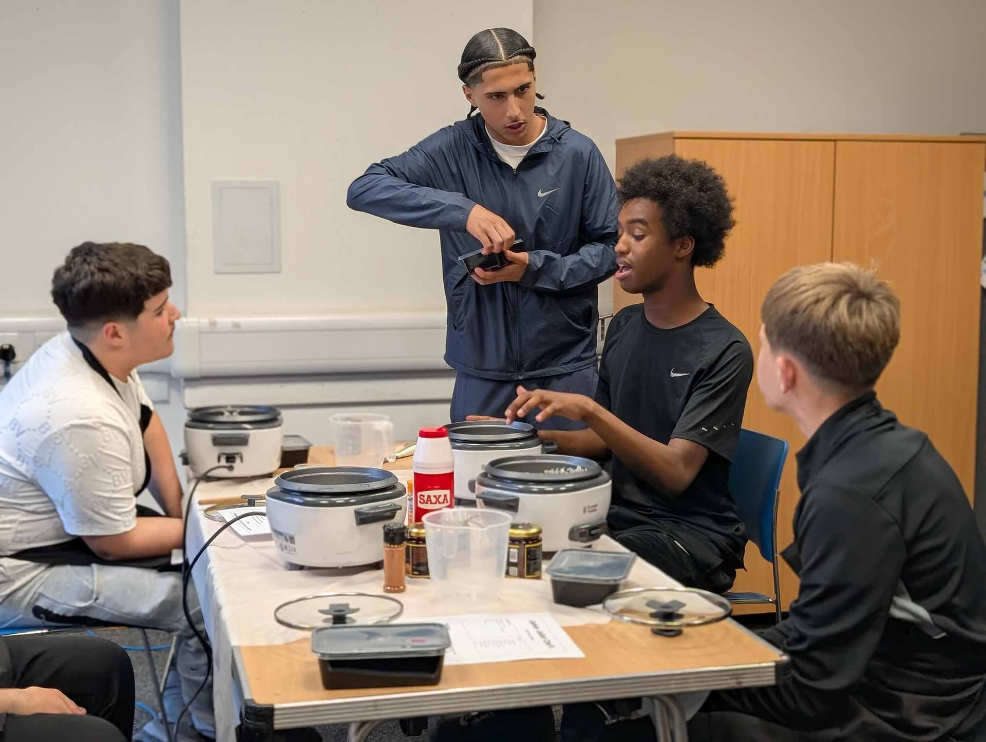 Students learning cooking skills